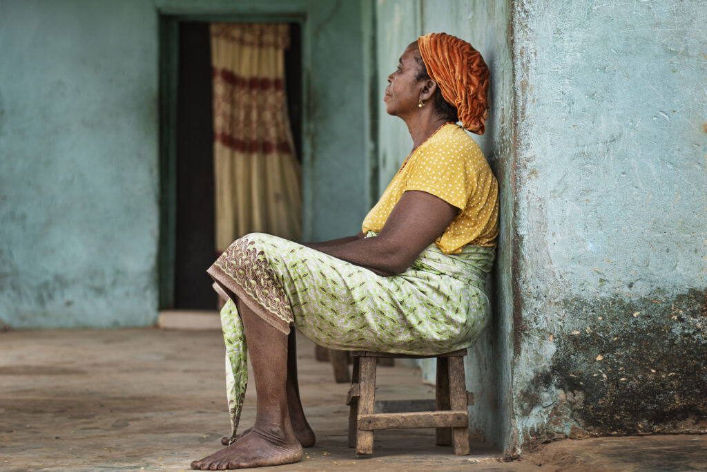 women sitting on a chair, in a situation of poverty. how to help social projects with no money